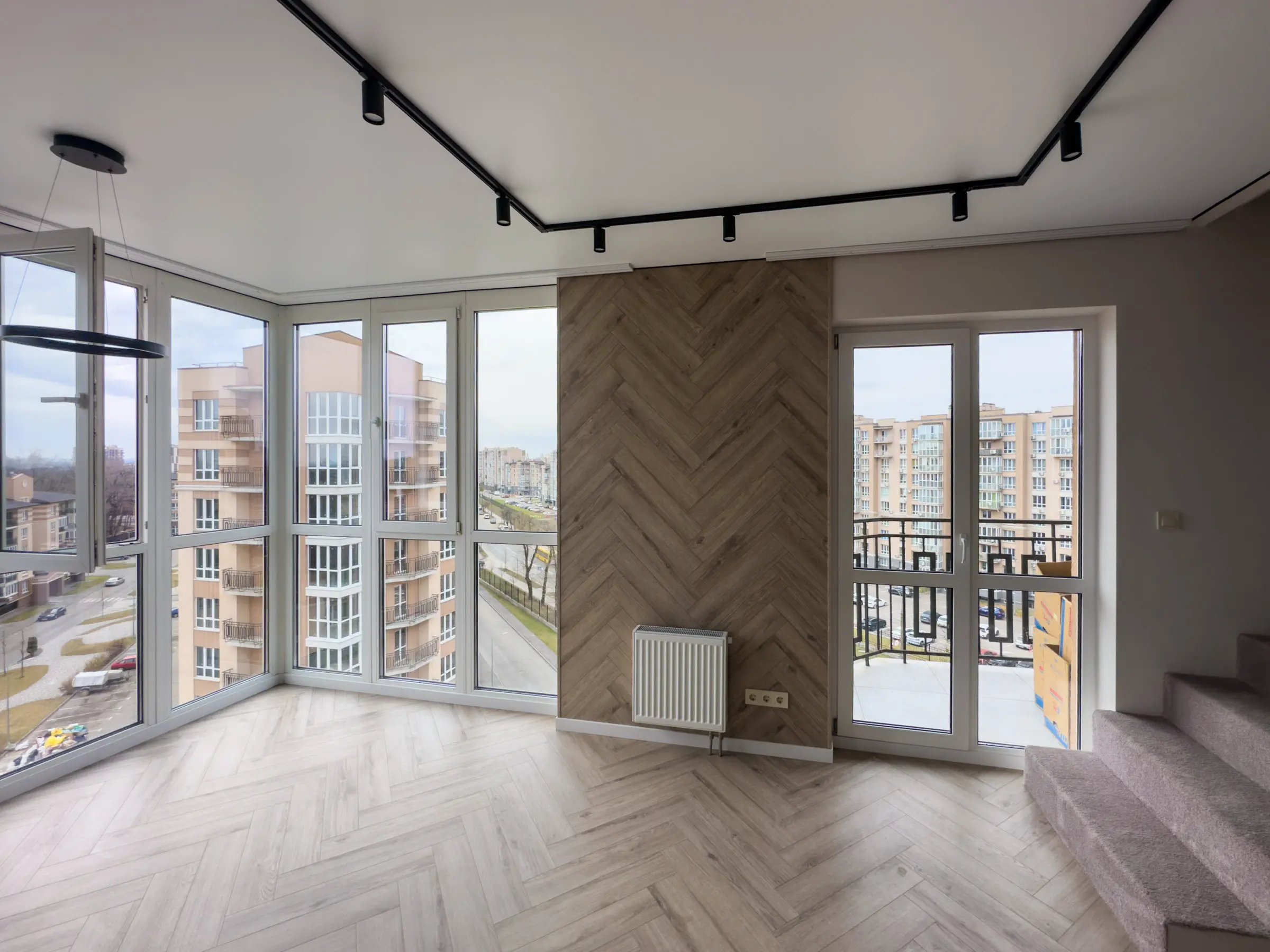Living room with herringbone vinyl flooring and a wood-effect decorative wall panel