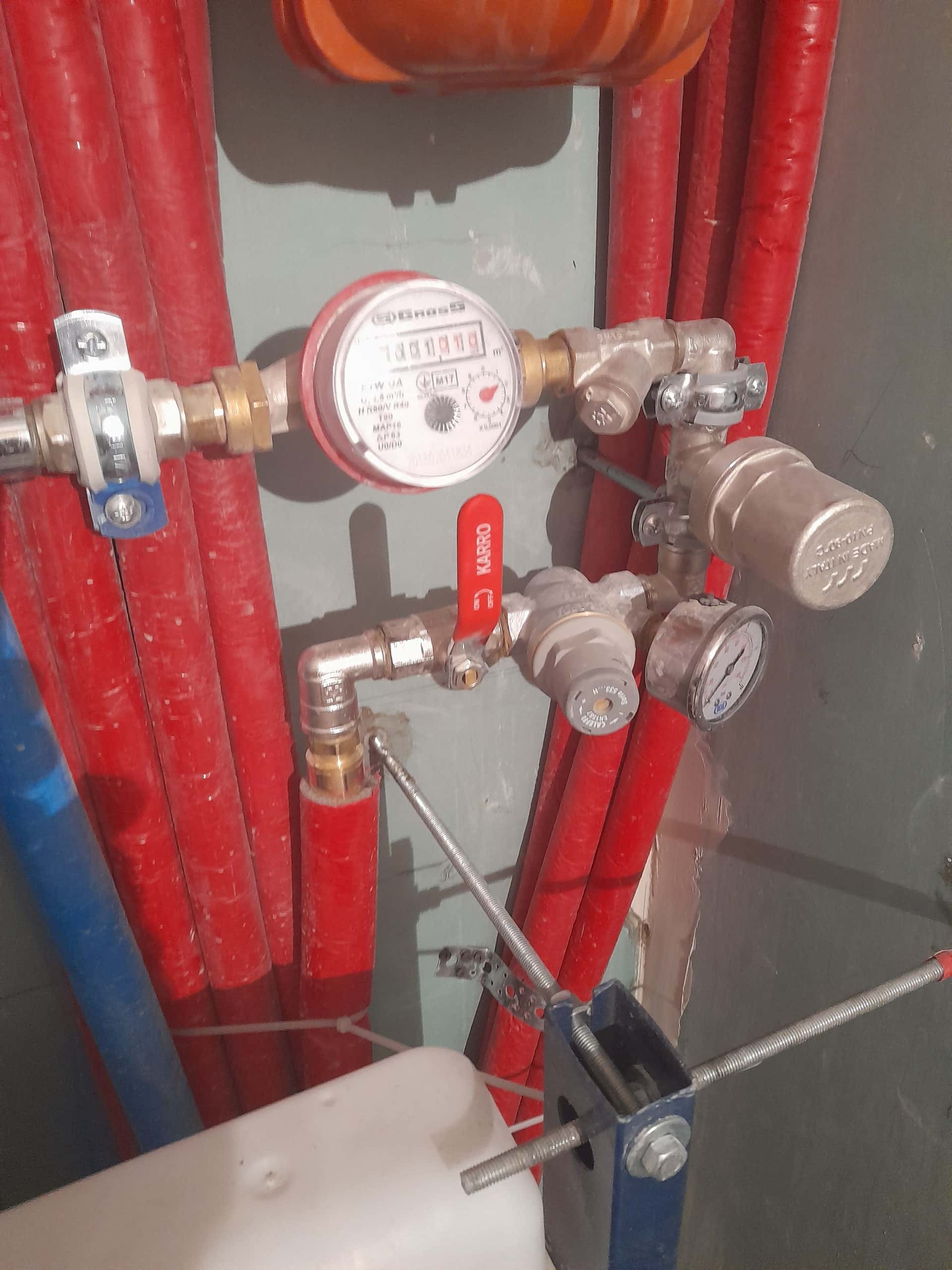 Water meter assembly with brass fittings, a KARRO ball valve, and a pressure gauge
